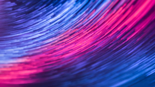A dynamic abstract image featuring swirling pink and blue lights in motion, creating a futuristic feel.
