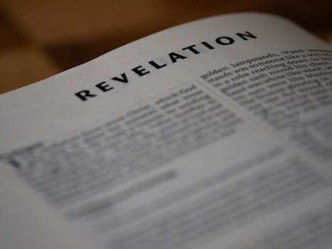 A close-up shot of the Book of Revelation from the Bible, emphasizing text.